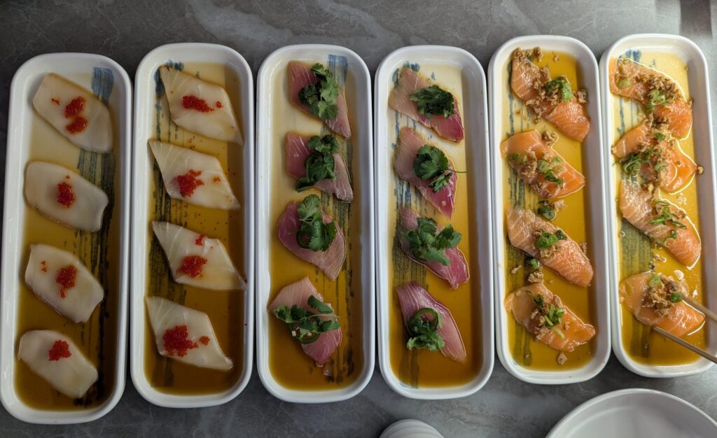 A picture of the carpaccio appetizer, with salmon, tuna and white tuna